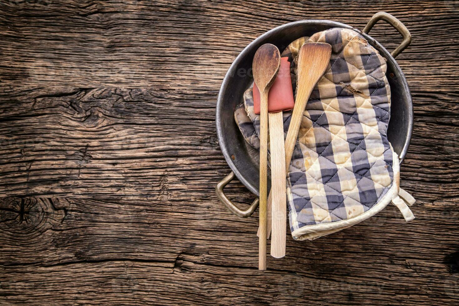 Top of view on Vintage kitchen utensils on rustic wood background. photo