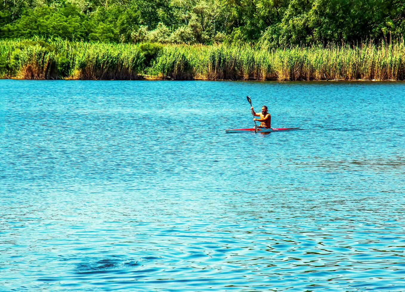 Technique of rowing of a single athlete on a kayak. Paddle splash motion. photo