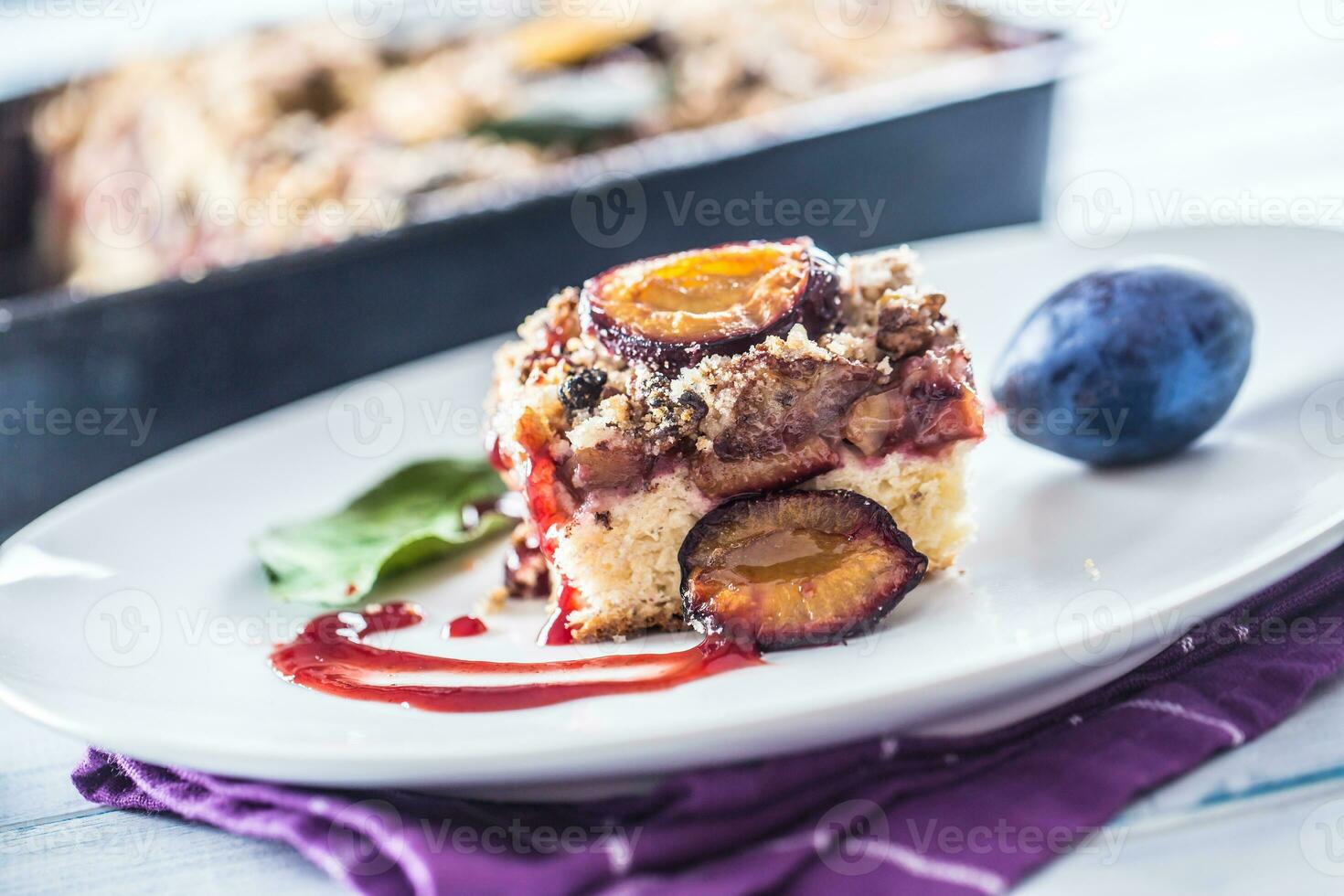 The traditional sweet plum cake on white plate photo