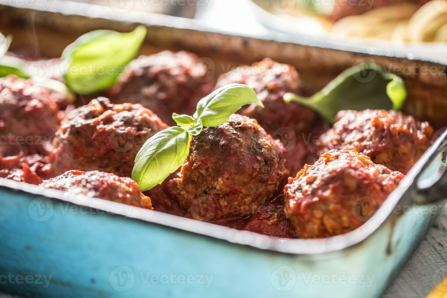 Delisious italian meal meat beef balls with basil in vintage roaster pan. photo