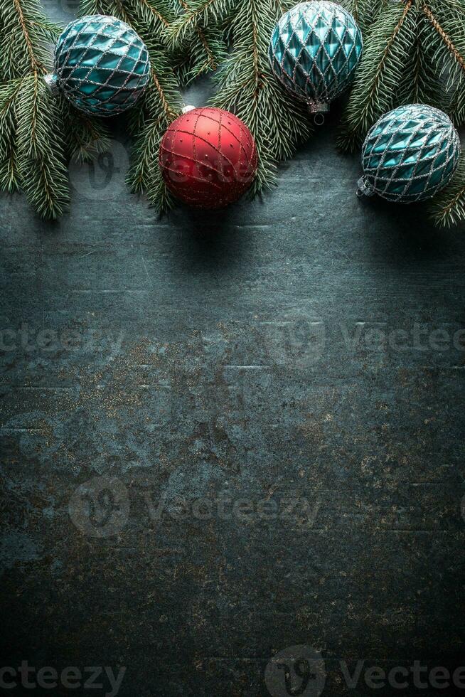 Top of view christmas balls fir tree pine cones on free concrete background photo