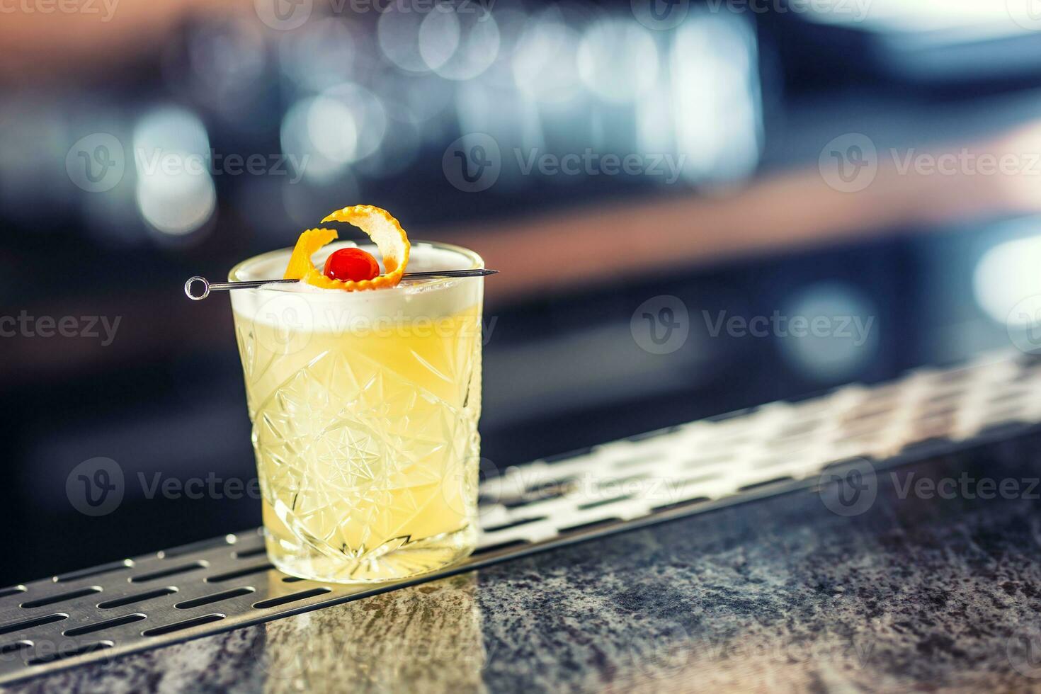 Cocktail drink whiskey sour at barcounter in night club or restaurant photo