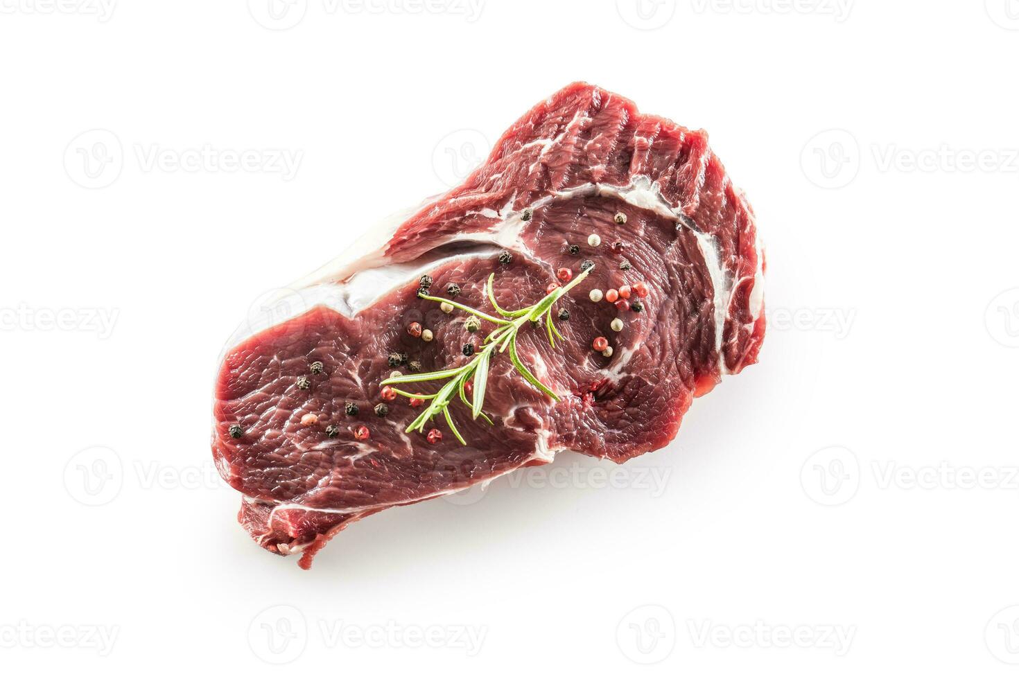 Beef Rib Eye steak with pepper and rosemary isolated on white background photo
