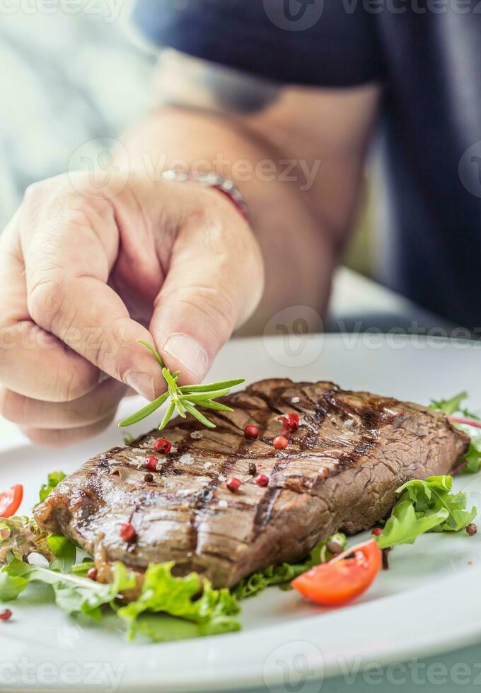 Chef prepared beef flank steak with vegetable decoration. photo