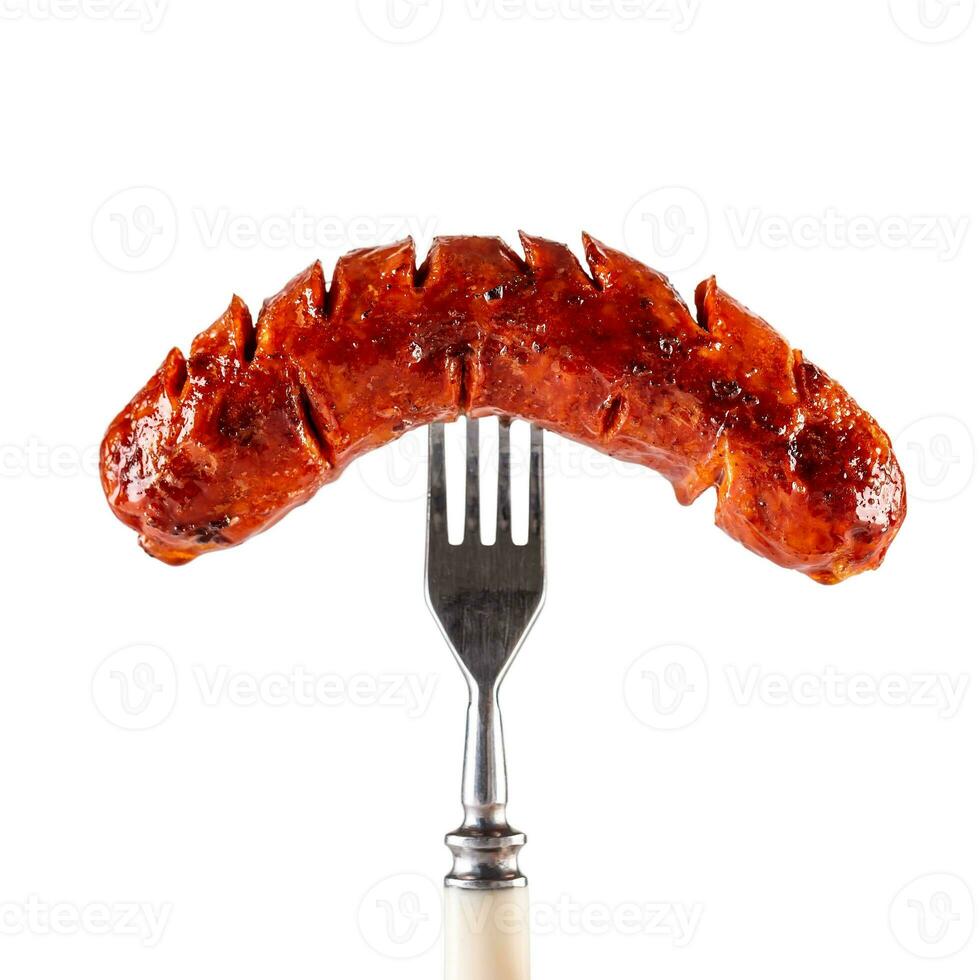 Roasted sausage on fork isolated on white background photo