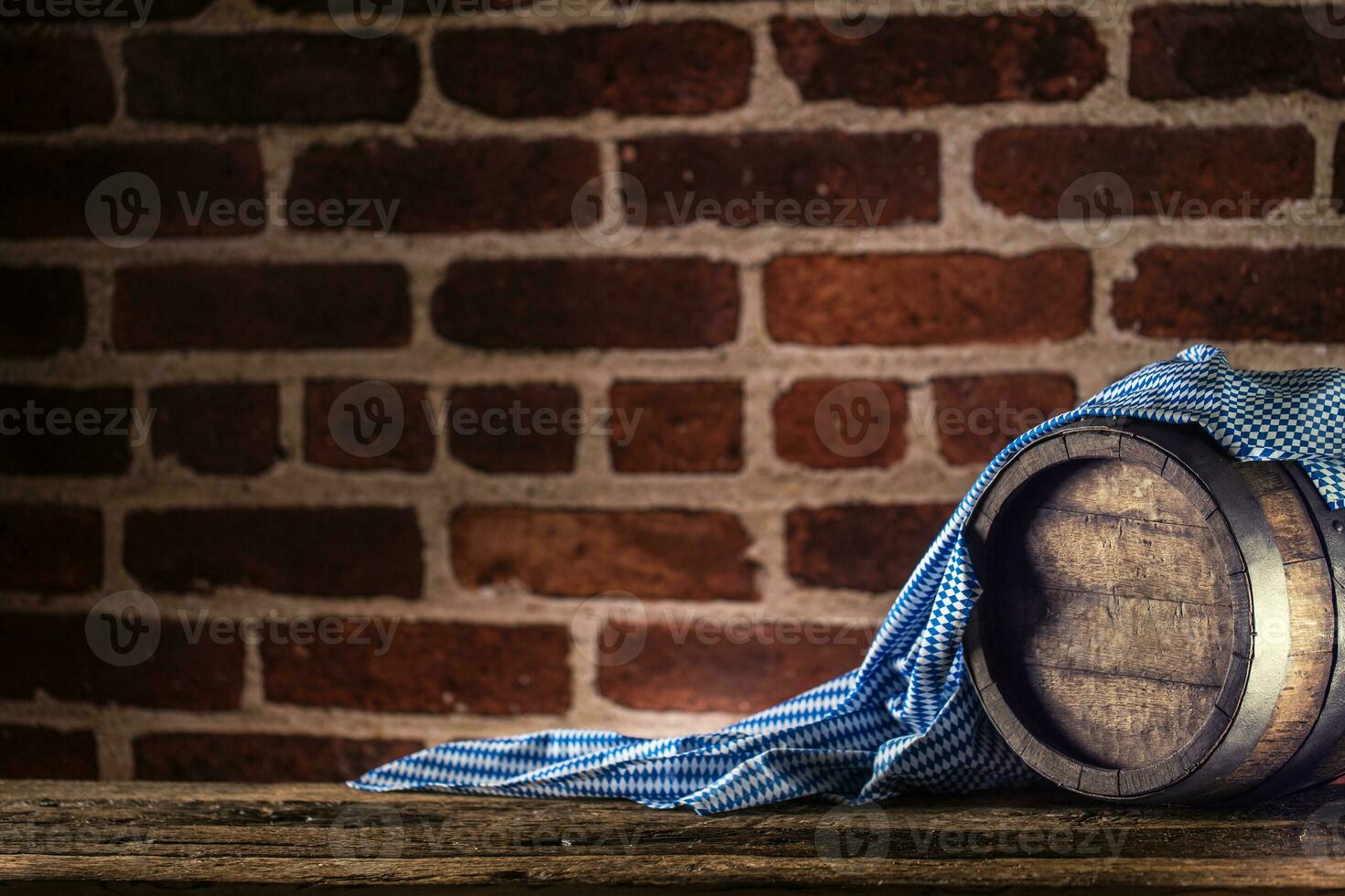 Oktoberfest wooden barrel and blue tablecloth on rustic oak table photo