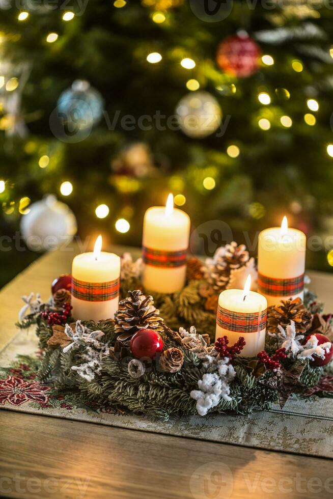Advent wreath with four white burning candles christmas ball and decorations on a wooden background with festive atmosphere photo