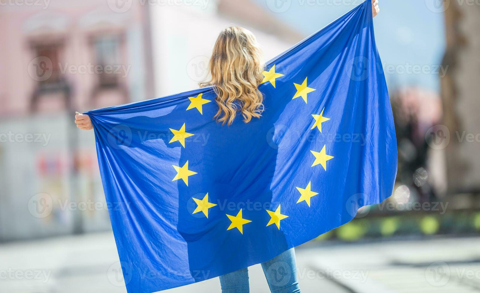 Attractive happy young girl with the flag of the European Union photo