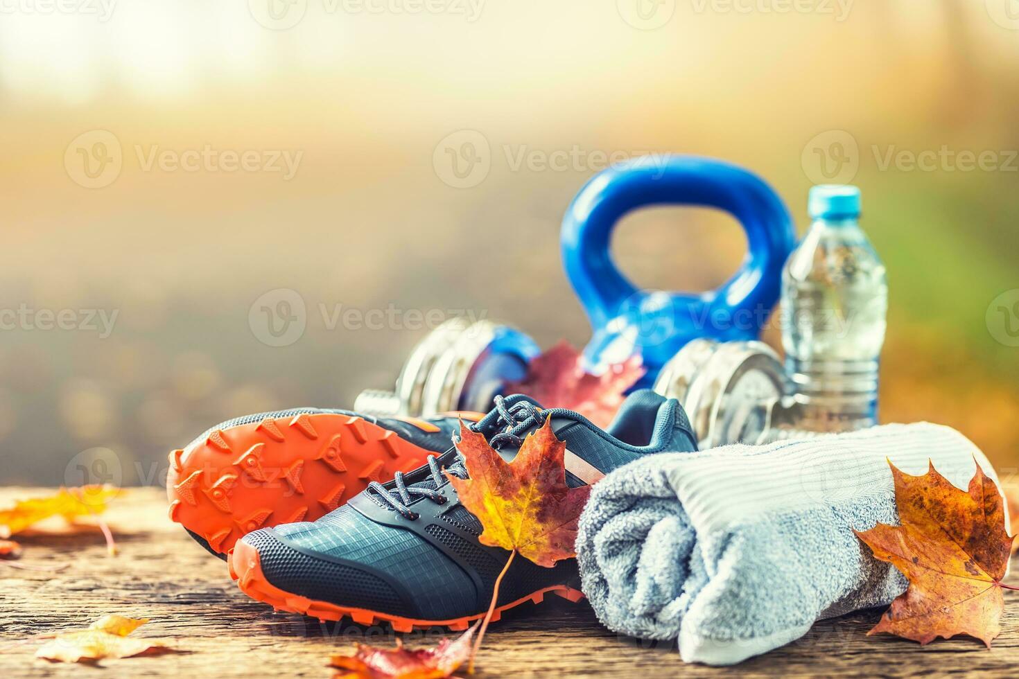 Blue sport shoes and water laid on a wooden board. photo