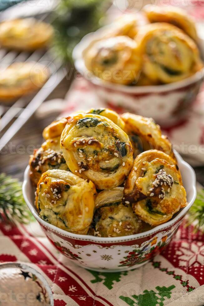 Christmas savory pastries, mini pizza cakes in a typical Christmas dish and festive decorations photo