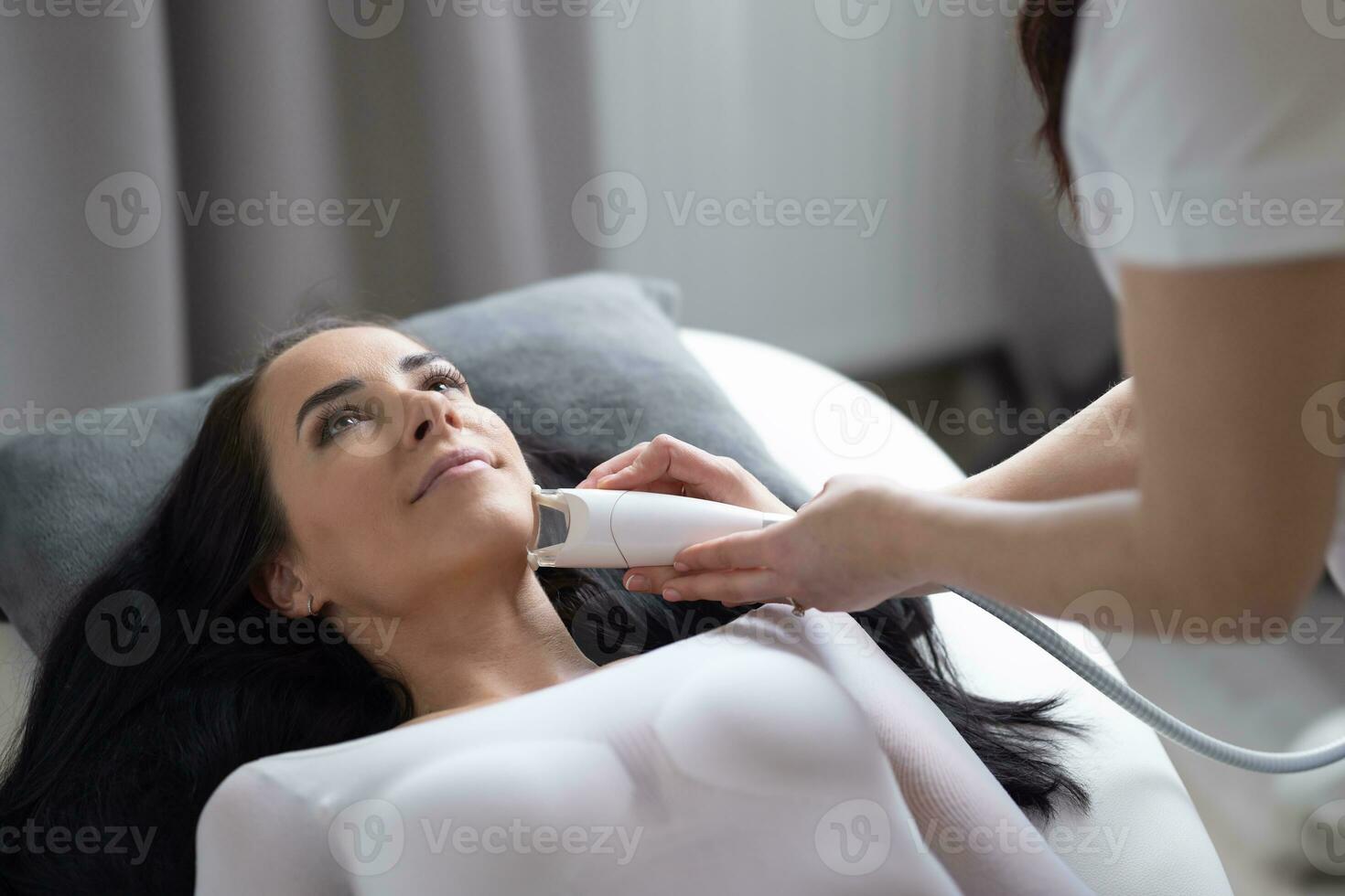 Cosmetician improves skin of a female client by a professional LPG endermology treatment photo