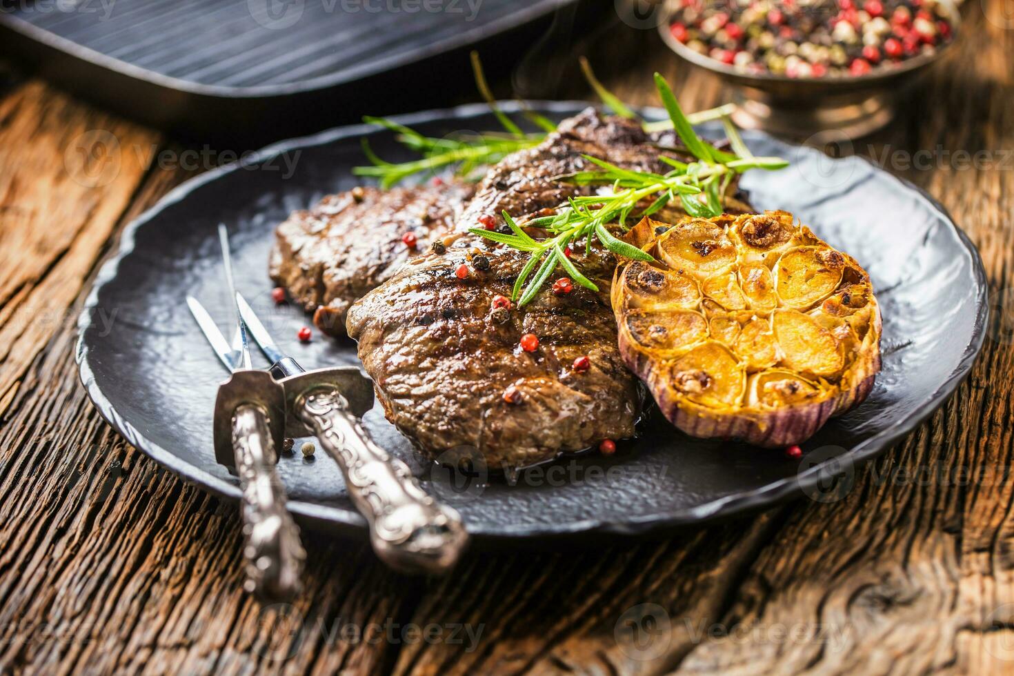 Grilled beef Rib Eye steak with garlic rosemary salt and spices photo