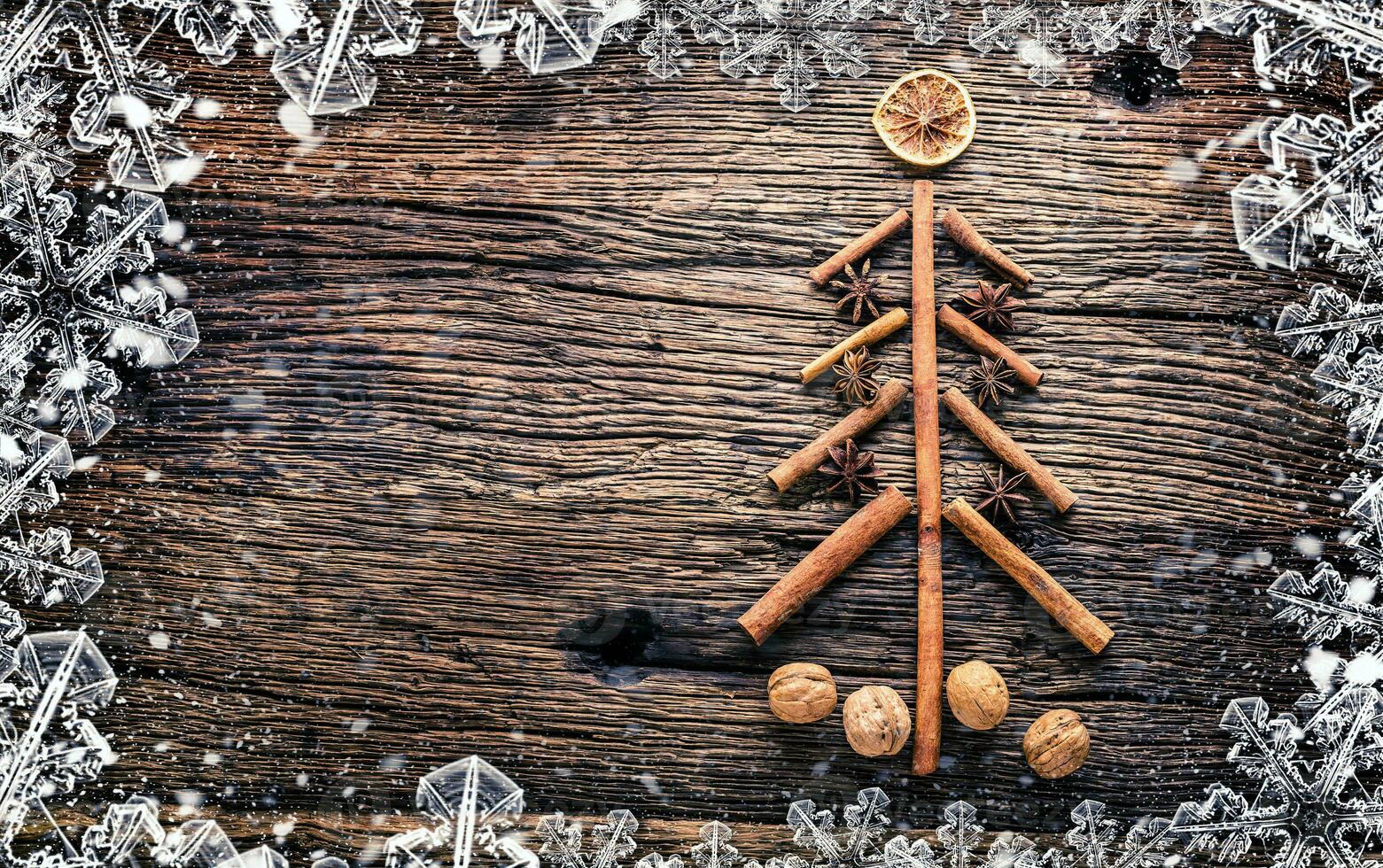 Christmas tree from cinnamon star anise and walnuts on rustich w photo