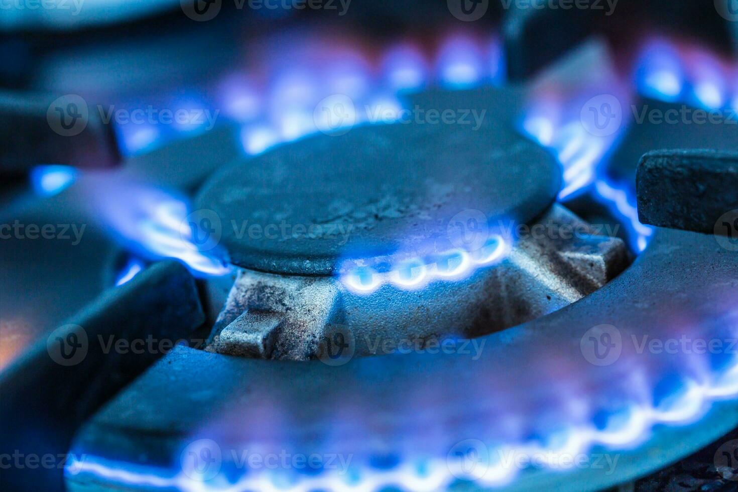 Close-up kitchen stove cook with blue flames burning photo