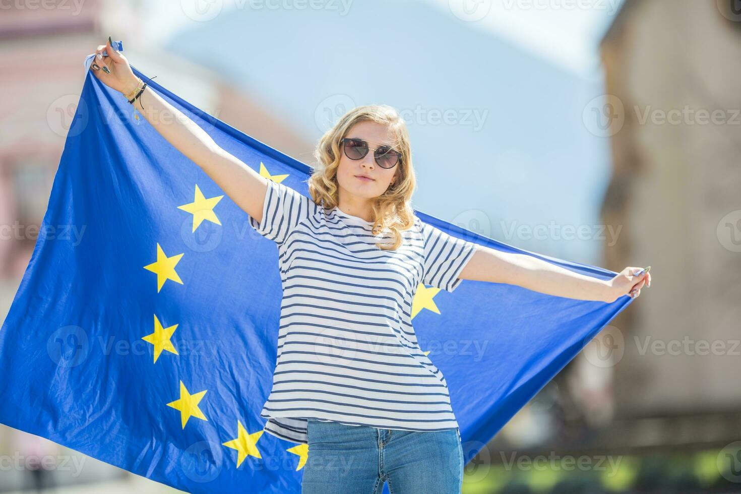 Attractive happy young girl with the flag of the European Union photo