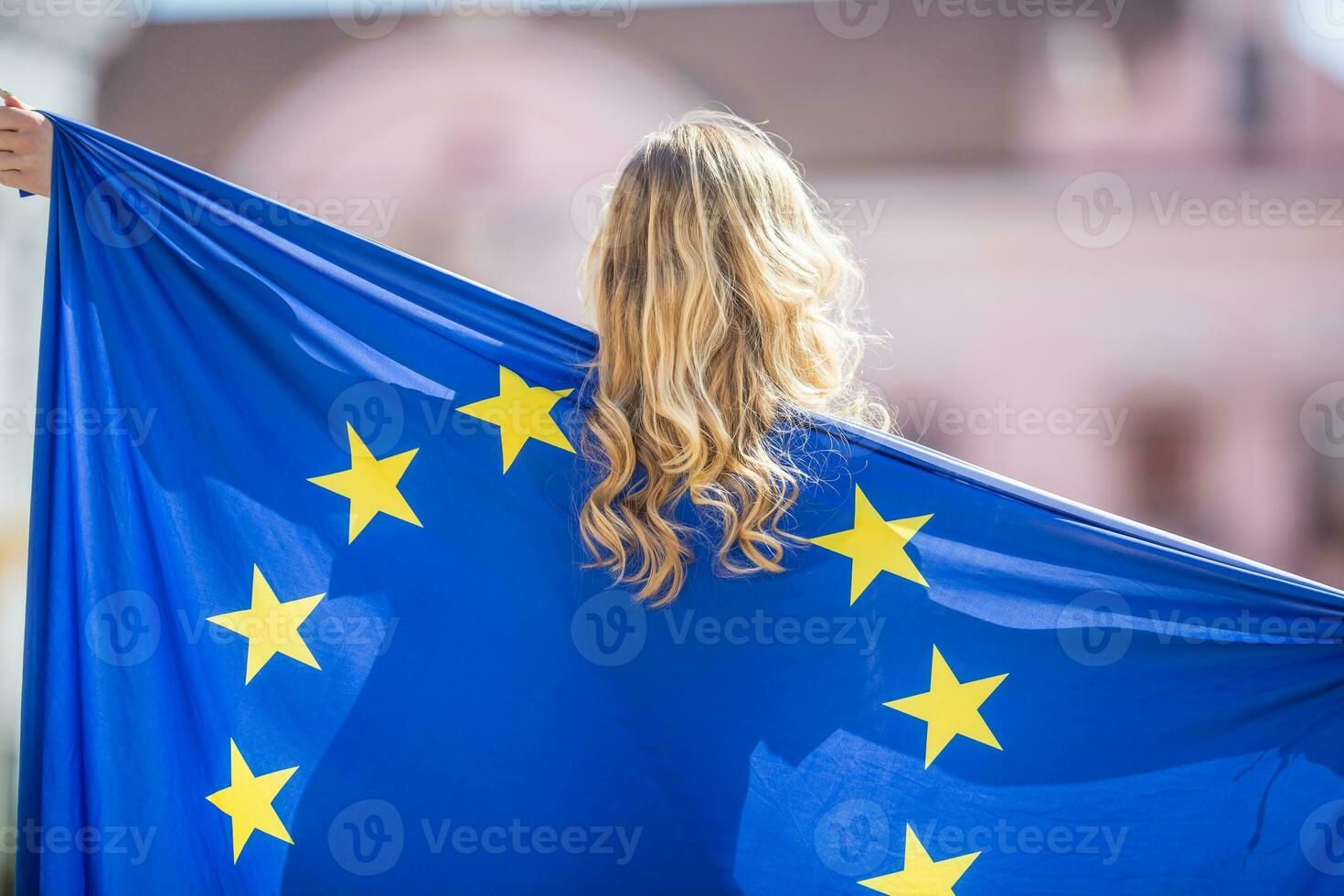 Attractive happy young girl with the flag of the European Union photo