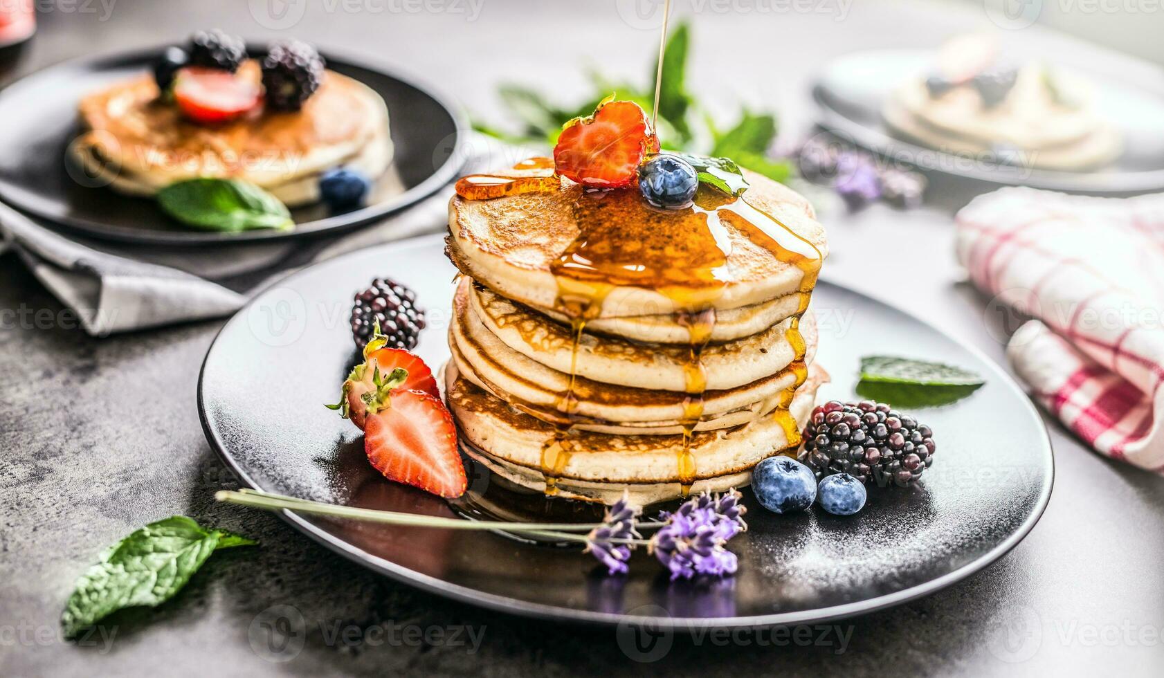 Pancakes with strawberries blackberries blueberries and levander. photo