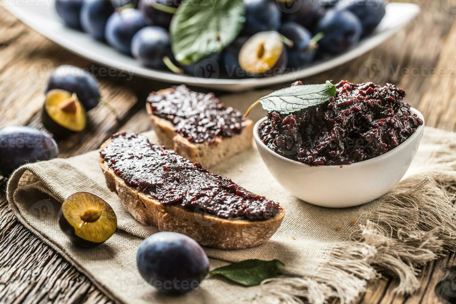 Breakfast from homemade plum jam bread and ripe plums. photo