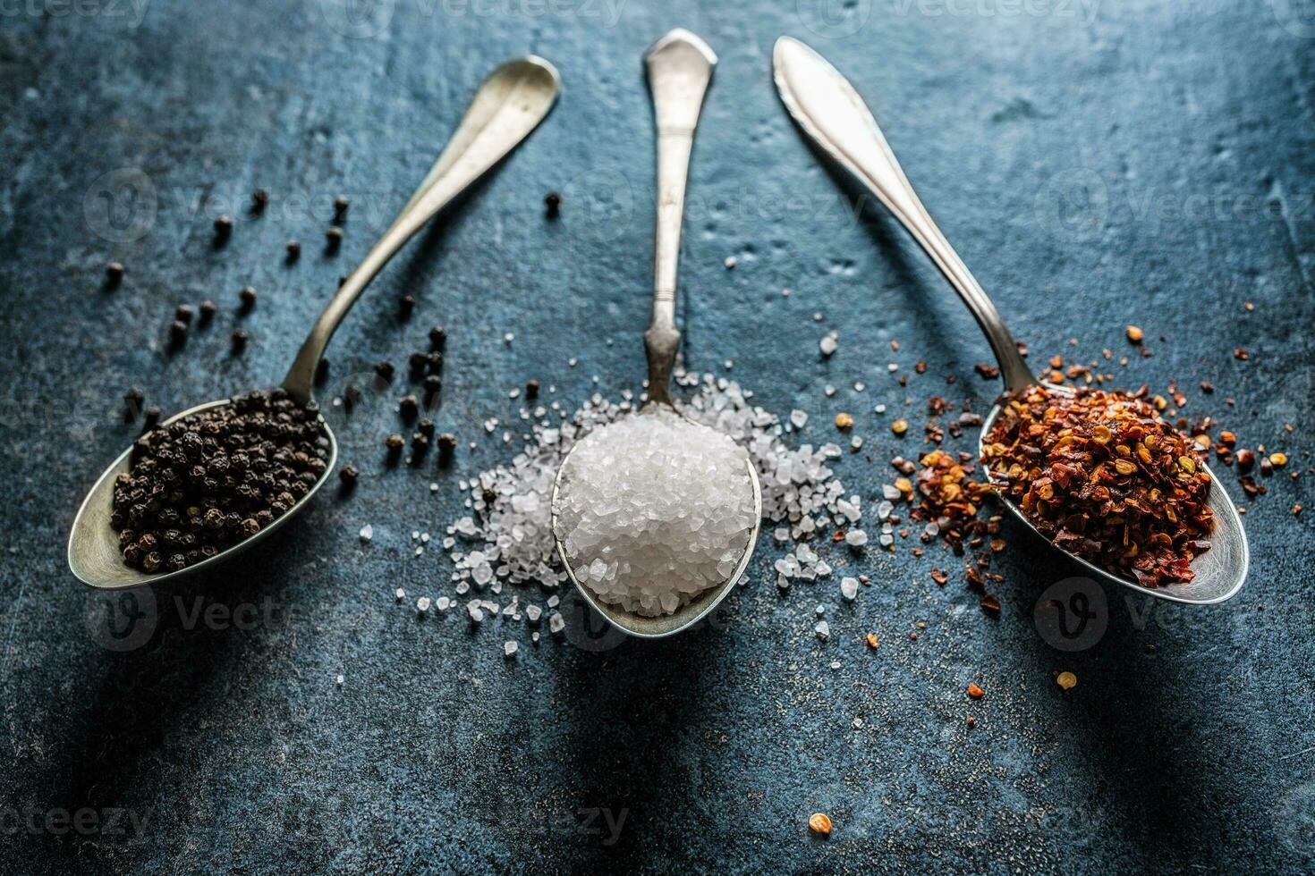 Three spoons full of salt chilli and black pepper photo
