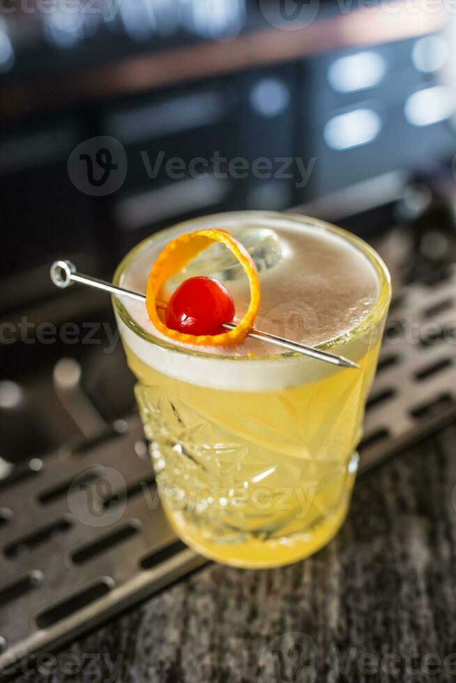 Cocktail drink whiskey sour at barcounter in night club or restaurant photo