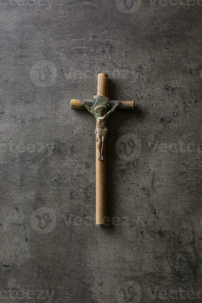 Vintage crucifix with Jesus Christ on concrete table photo