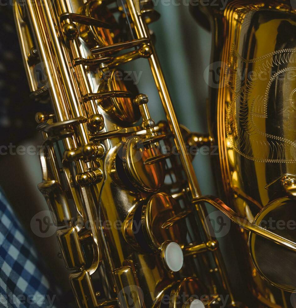 Gold Alto saxophone on a green background photo