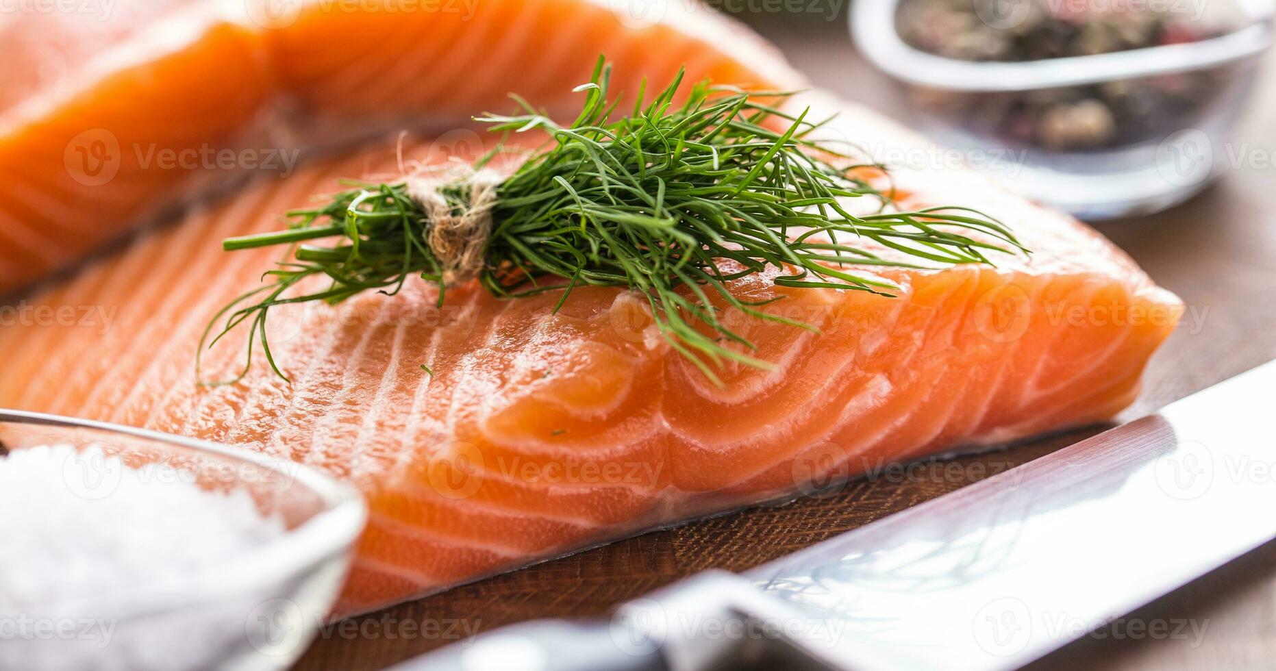 Raw salmon fillet with dill lemon olive oil salt and pepper photo