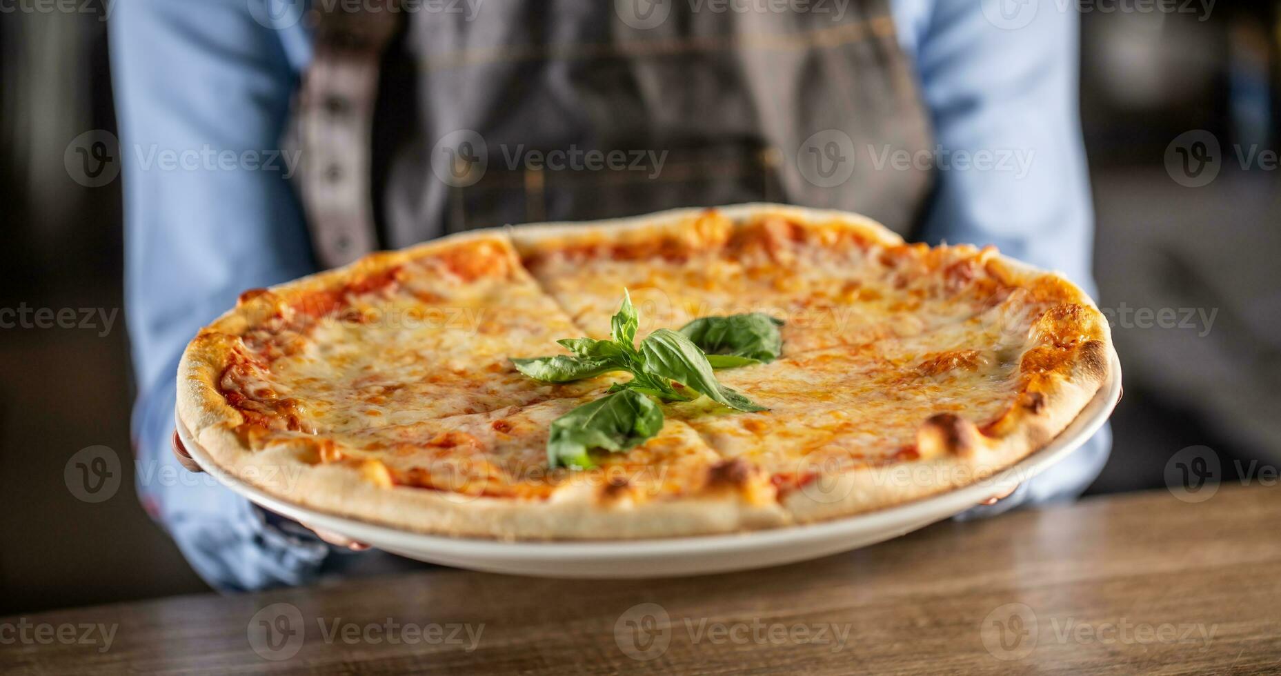 Quattro formaggi pizza with four types of cheeses, crusty edges and fresh basil on top photo