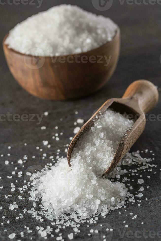 Crystaline sea salt in bowl and spoon - closeup photo