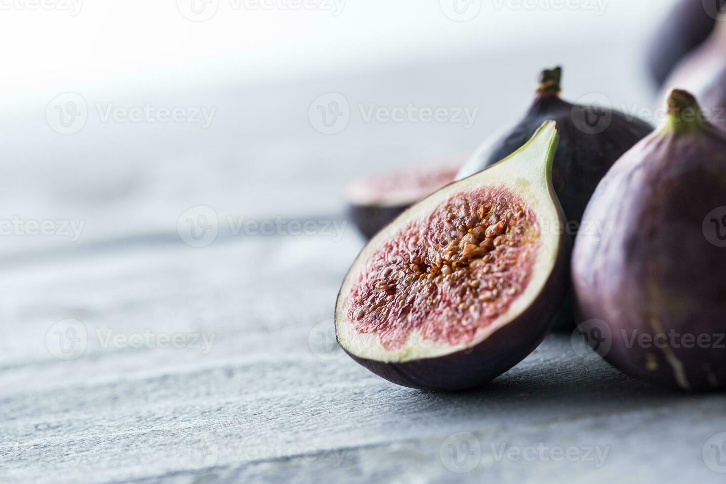 A few figs freely lying on old wooden table photo