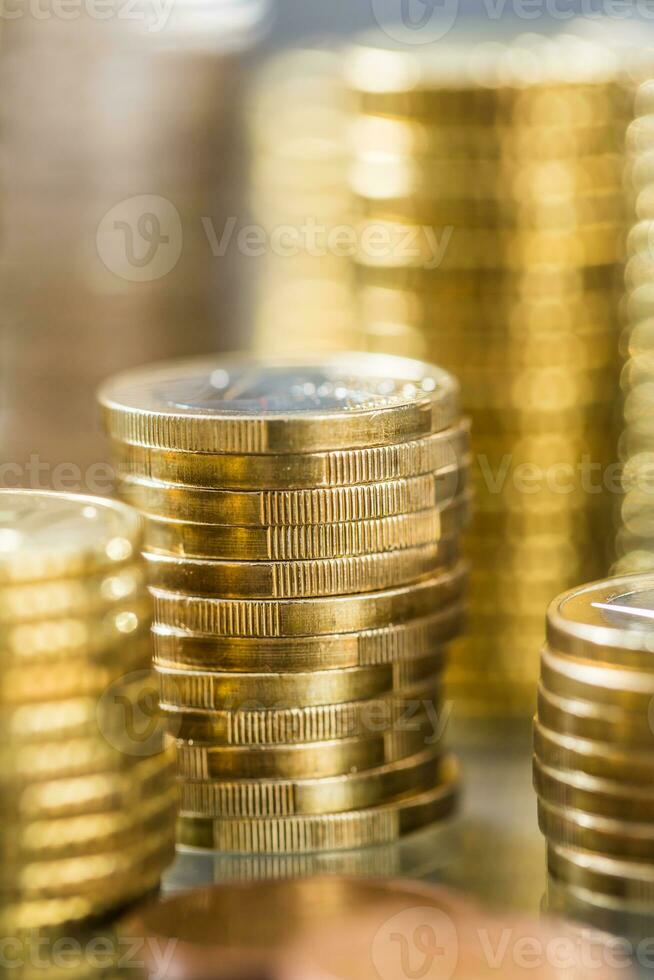 Towers of the euro coins stacked in different positions photo