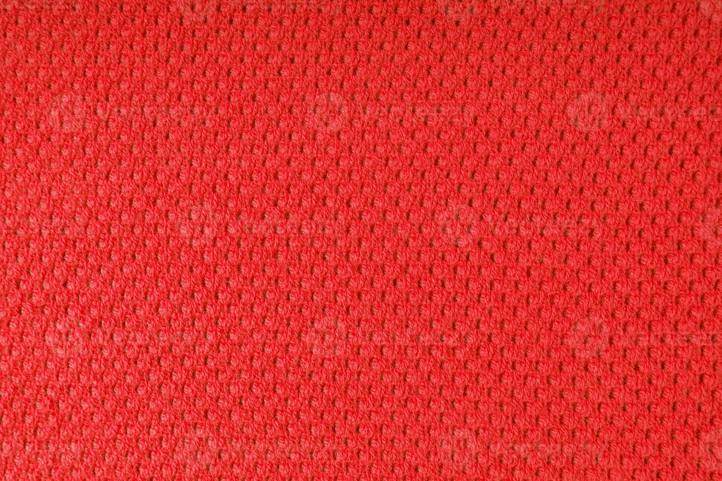 Bright red knitwear wool fabric texture background. Abstract textile backdrop photo