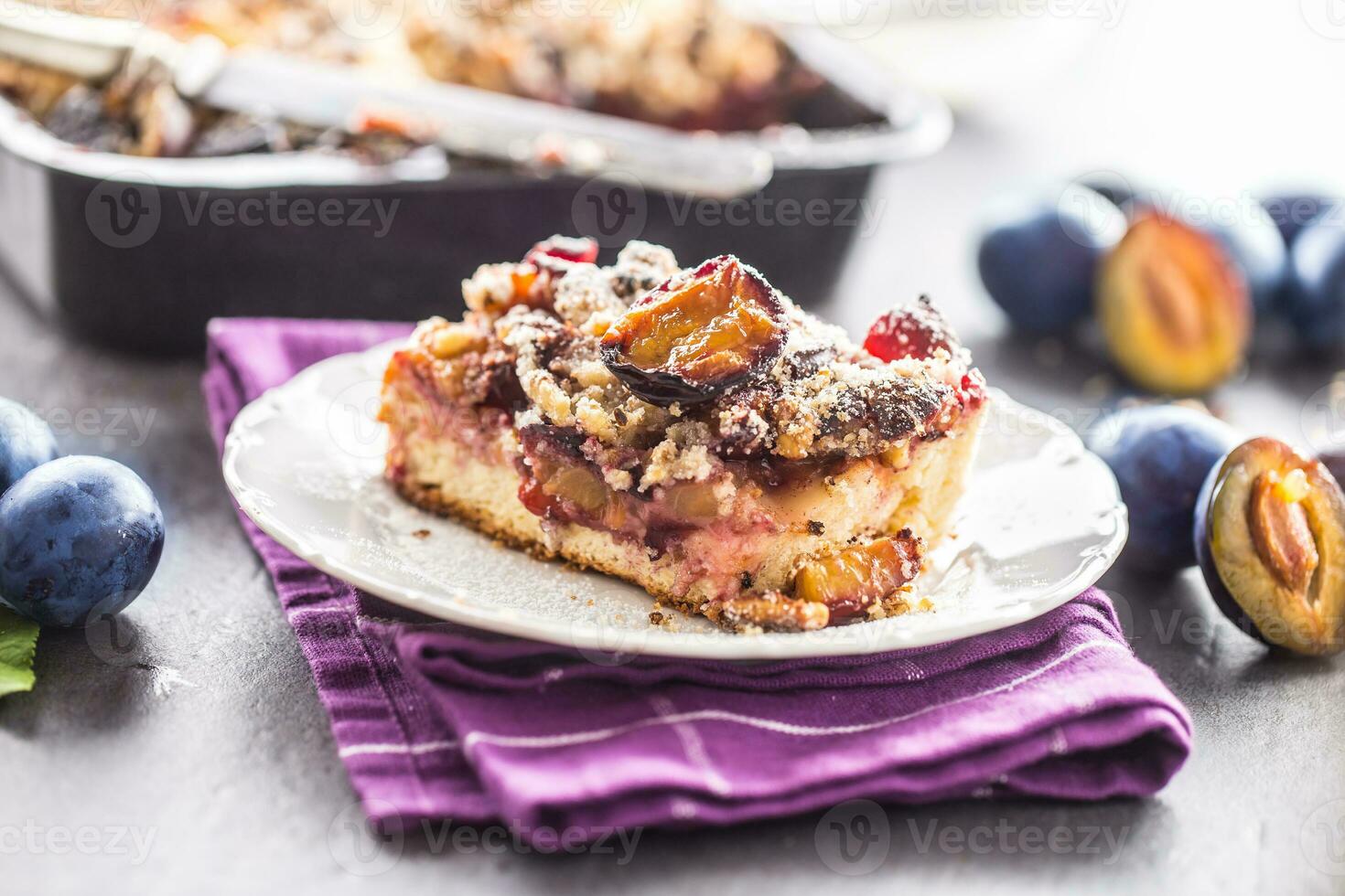 The traditional sweet plum cake on white plate photo
