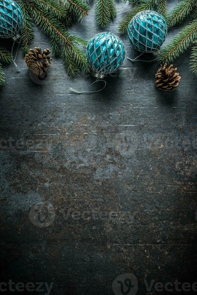 Top of view christmas balls fir tree pine cones on free concrete background photo