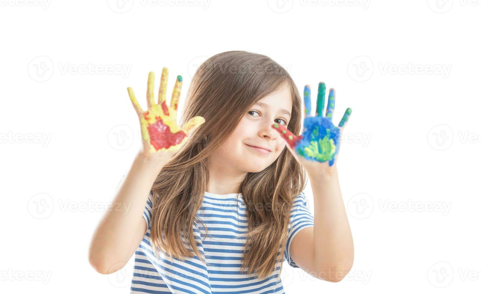 Little schoolgirl shows hands painted with watercolors - isolated on white photo