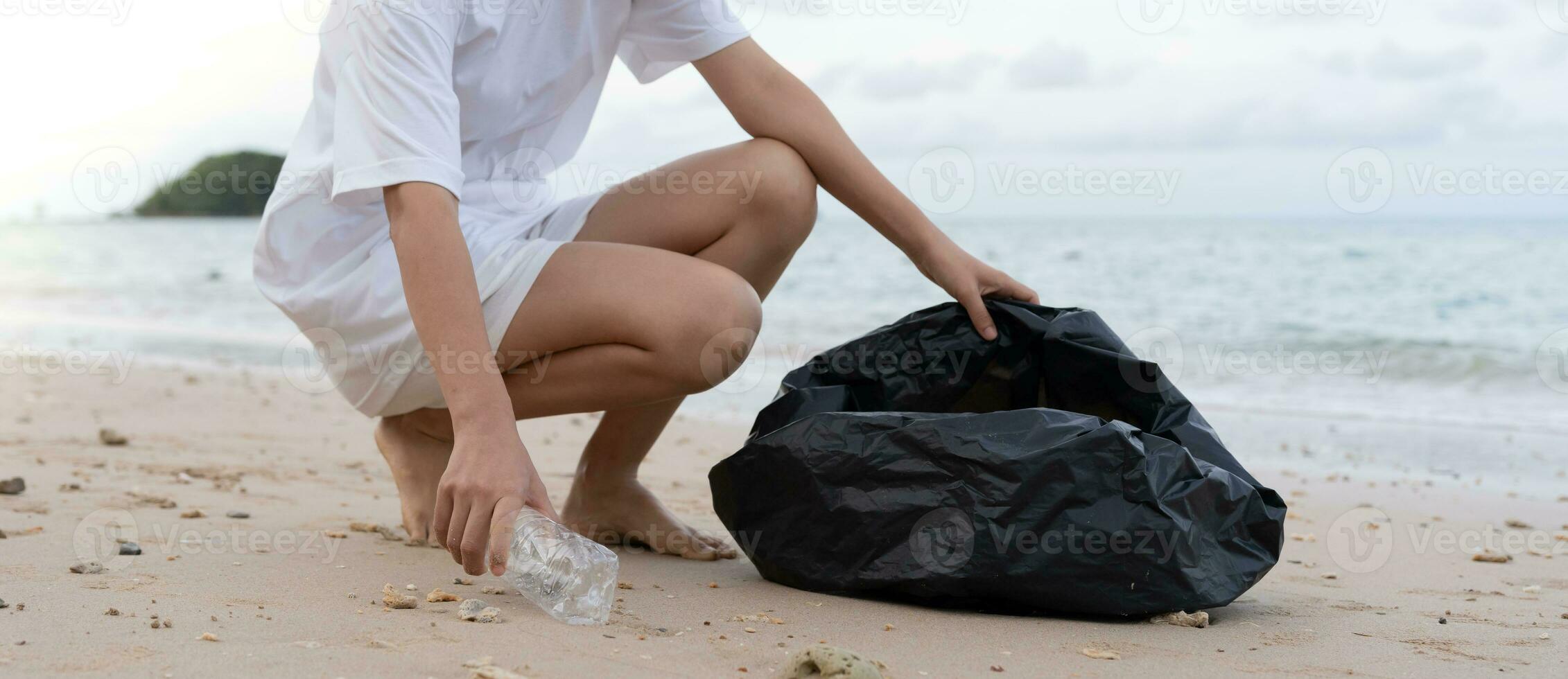 Save water. Volunteer pick up trash garbage at the beach and plastic bottles are difficult decompose prevent harm aquatic life. Earth, Environment, Greening planet, reduce global warming, Save world photo