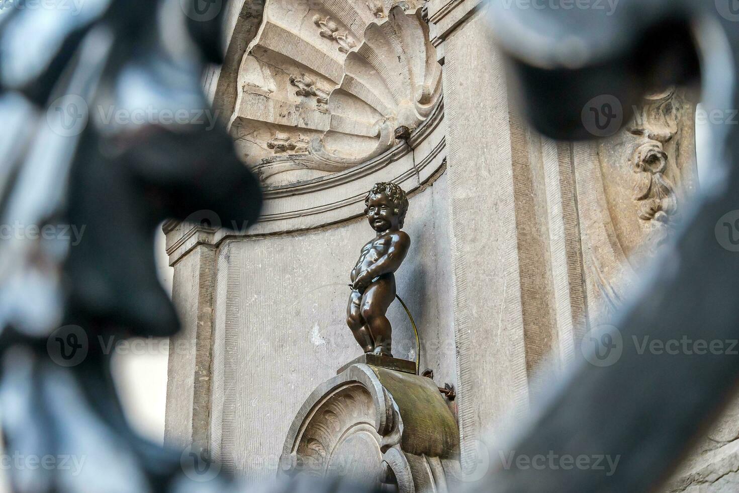 Manneken Pis Little man Pee or le Petit Julien, a very famous bronze sculpture landmark in Brussels photo