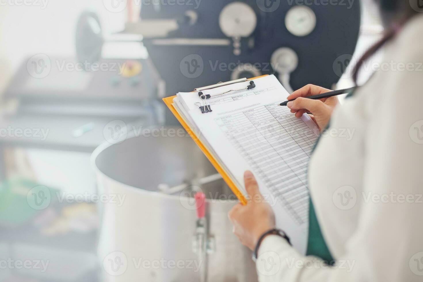 a woman holding a clipboard while looking at a piece of paper photo