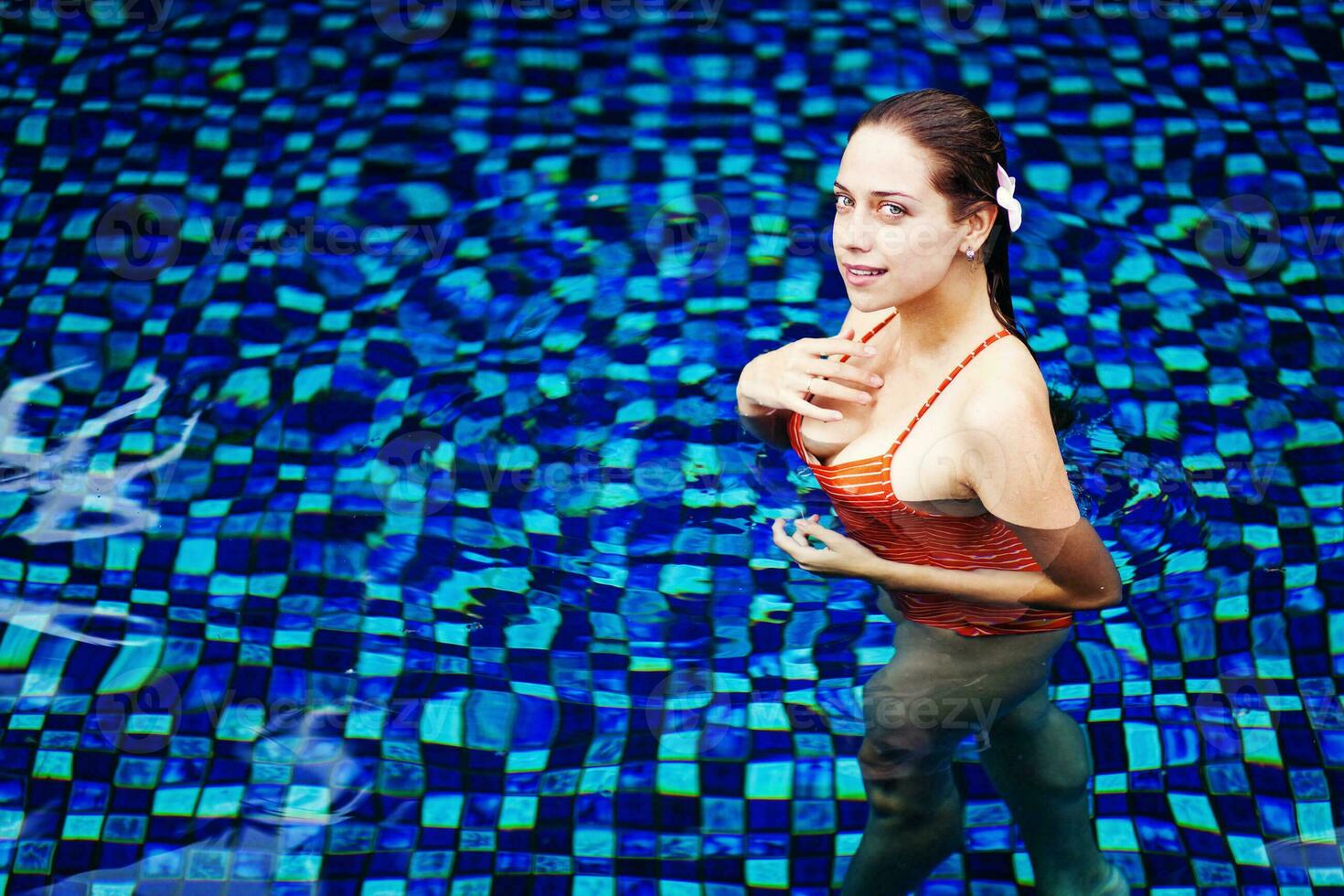 Beautiful woman on the swimming pool photo