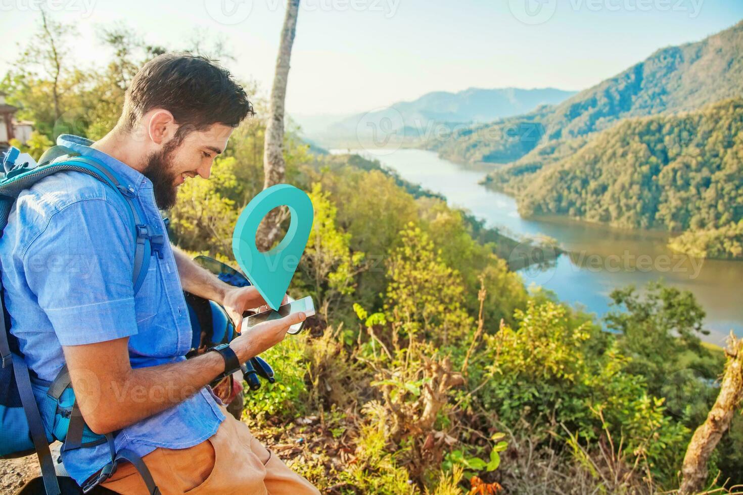 man using a map while hiking in the mountains photo