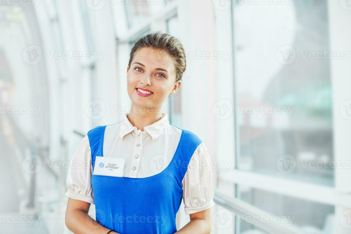 Beautiful young flight attendant in the airport. photo