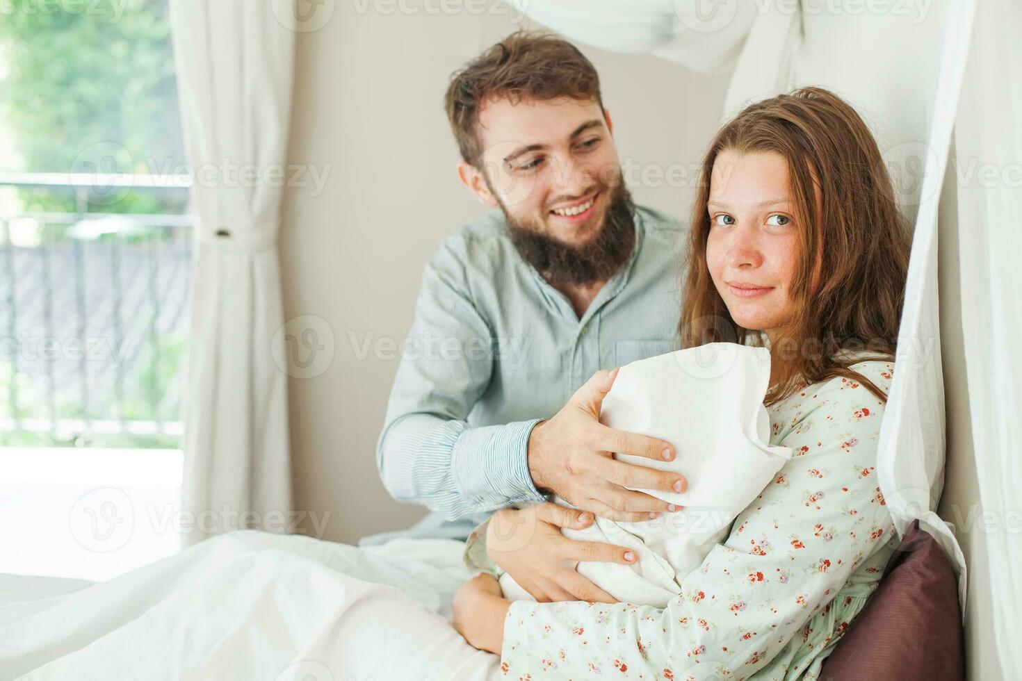 a man and woman are holding a baby photo