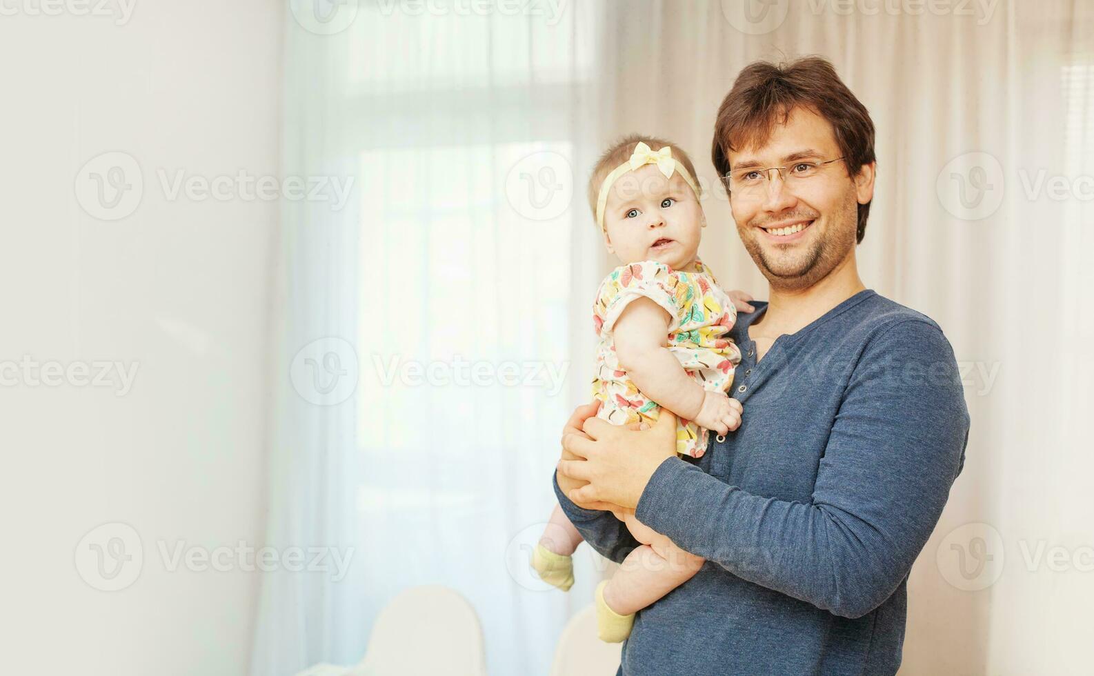 a man holding a baby in his arms photo