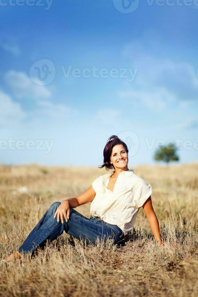 Beautiful woman in a field photo