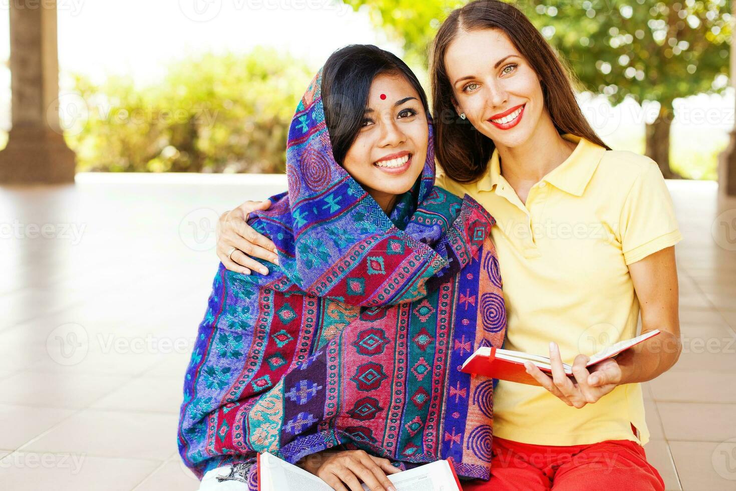 two women sitting on the ground photo