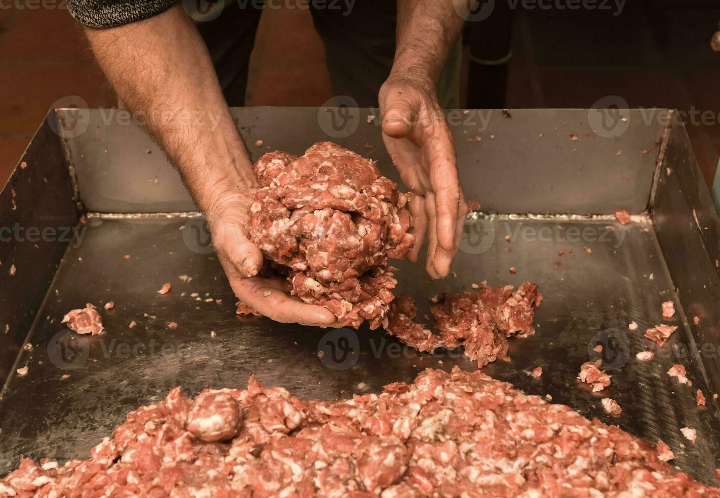 Hands cooking,Minced meat, sausage traditional preparation, Pampas, Argentina photo