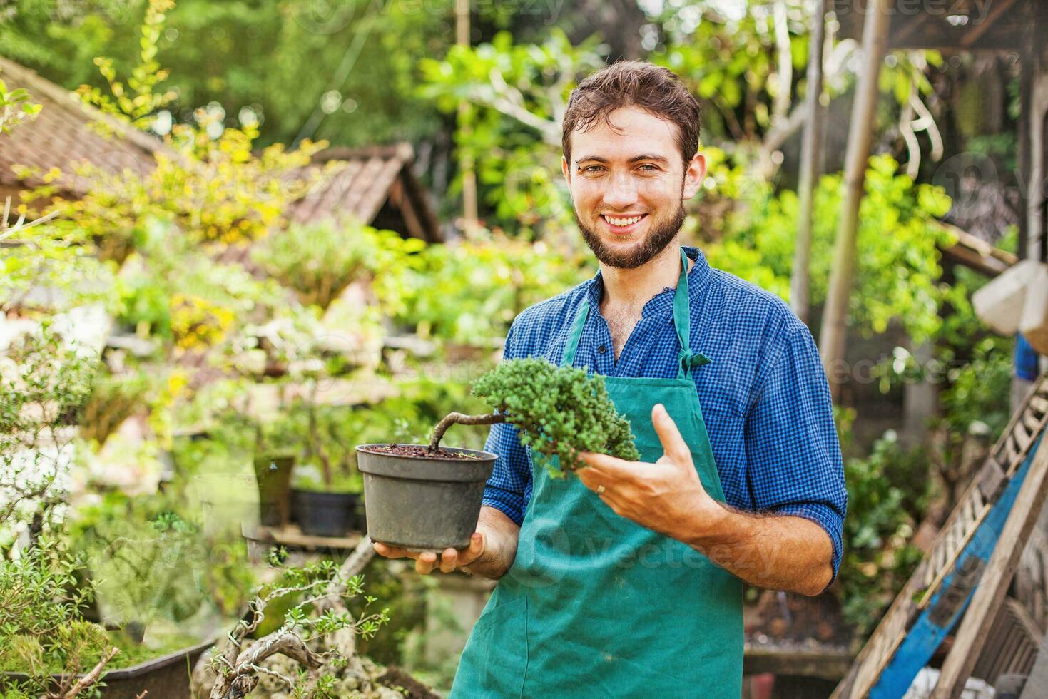 a man is standing in front of a flower shop photo