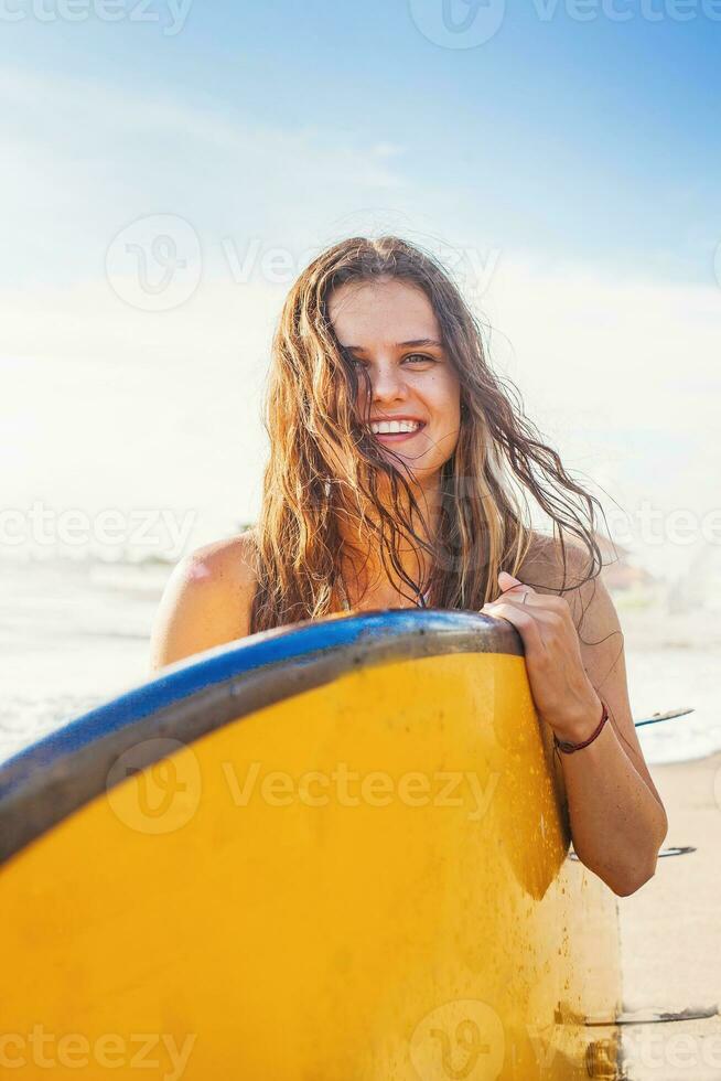 Surfer girl at the beach photo