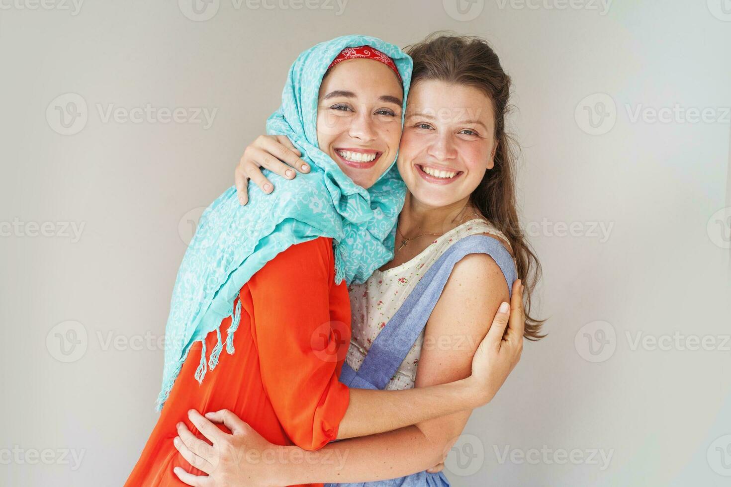 friendship of the religions concept muslim and christian girl together photo