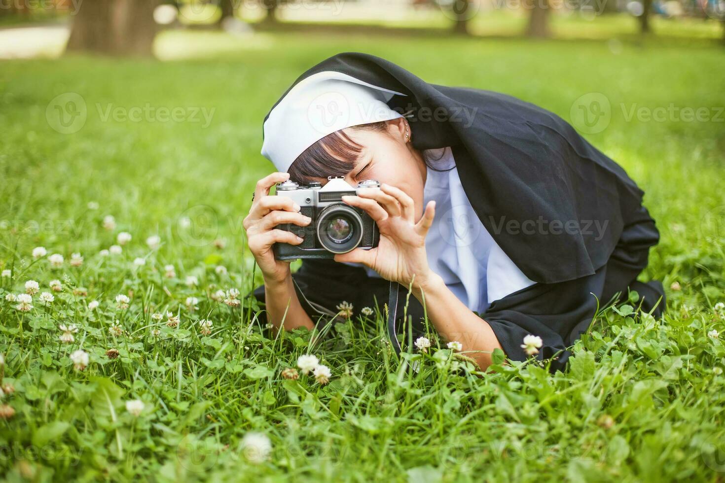 a nun taking a photo with a camera